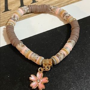 Heishi two bracelet stack with a charm